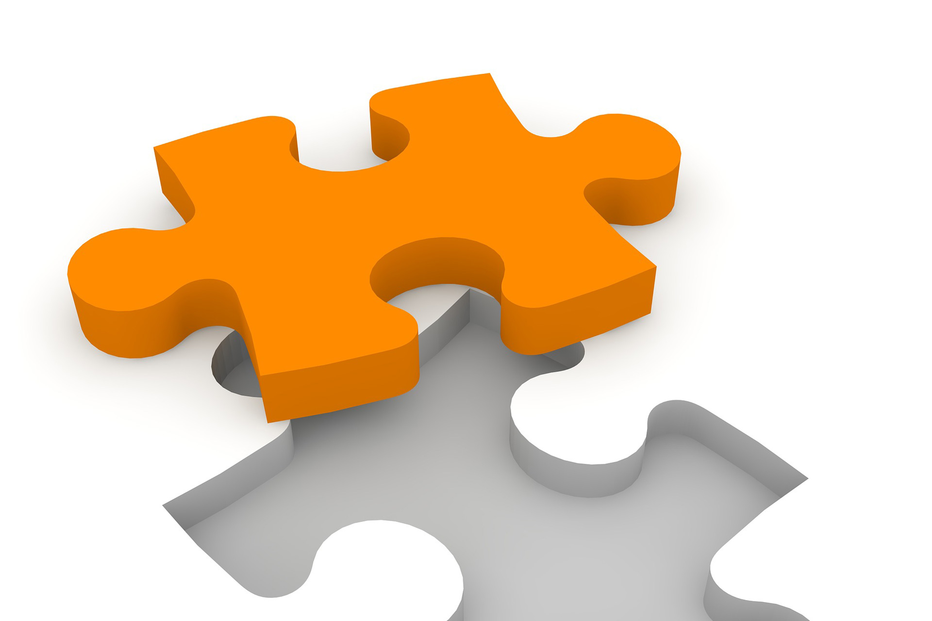 Puzzle piece in orange about to be placed. Illustrates the key piece to a FP&A system concept.